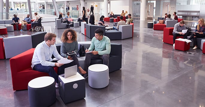 Students sitting in university atrium